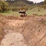 How to Dig a Pond With a Backhoe